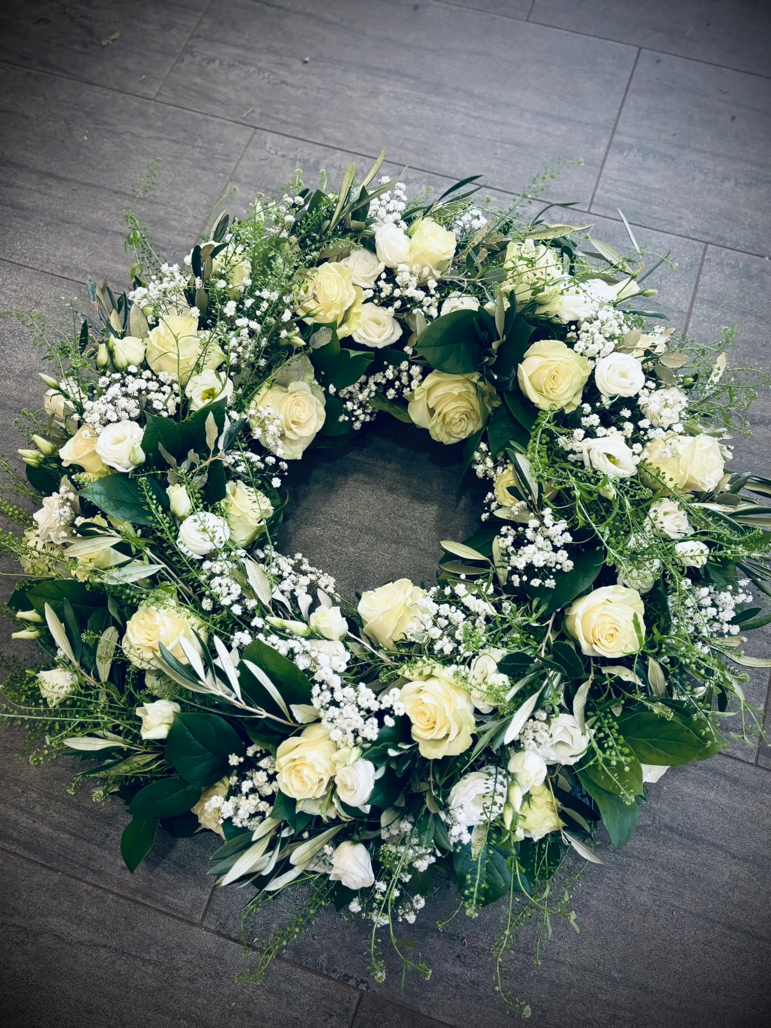 Trauerkranz aus weißen Rosen und Schleierkraut